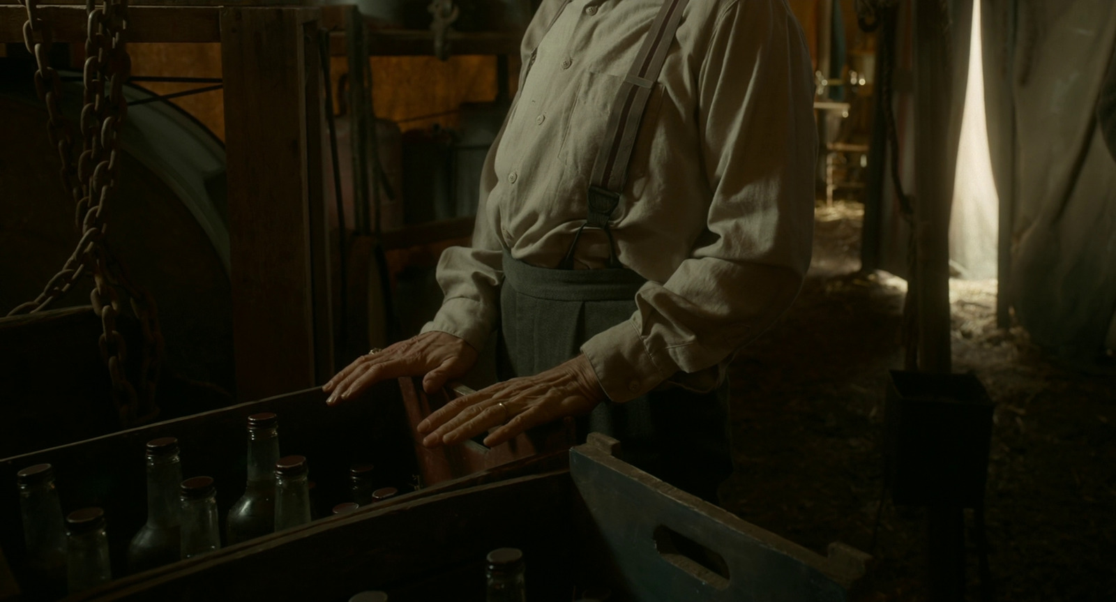 a man standing in a room with bottles