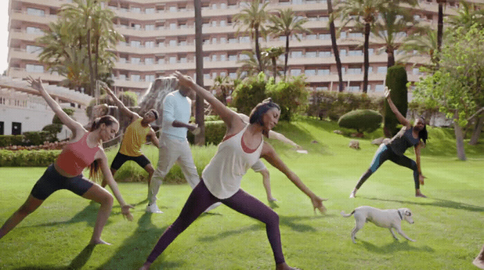 a group of people doing yoga in a park