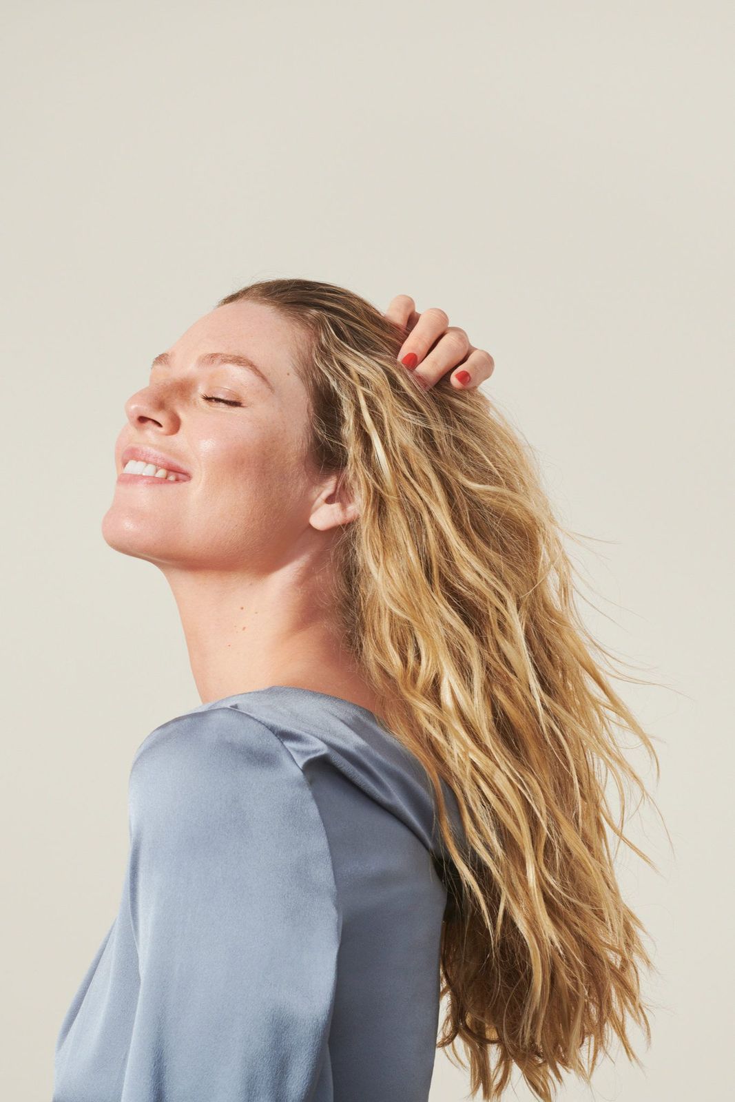 a woman with her hair blowing in the wind