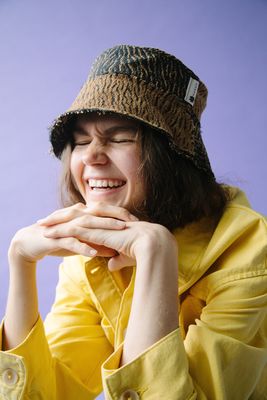 a woman wearing a yellow shirt and a hat