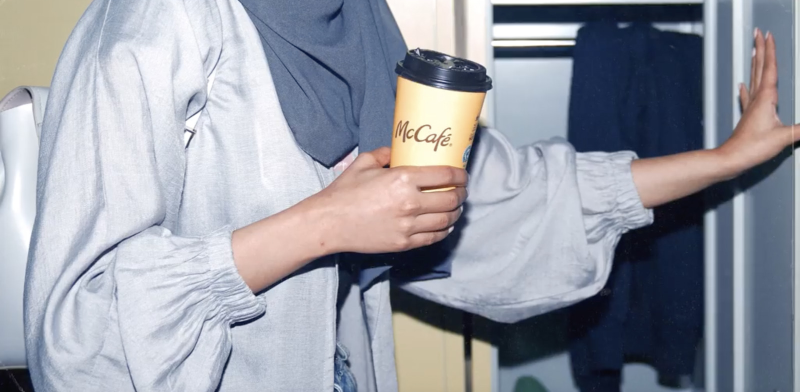 a woman holding a coffee cup in her hand