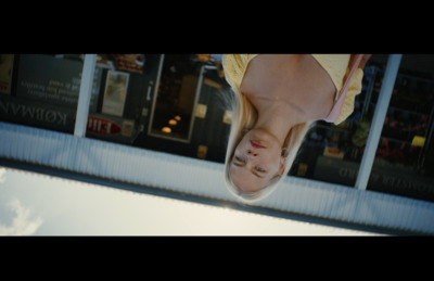 a woman is upside down in front of a store