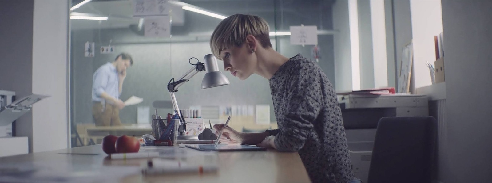 a man sitting at a desk with a laptop computer