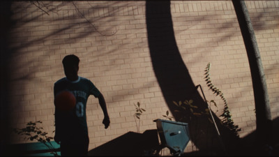 a man standing in front of a brick wall