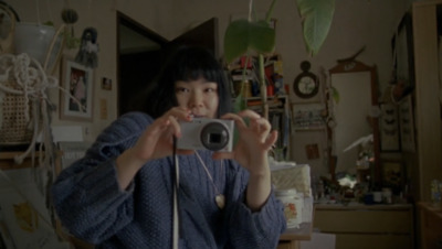 a woman taking a picture of herself with a camera