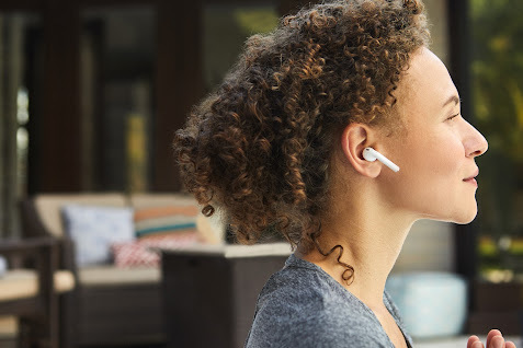 a woman with ear buds on her ears