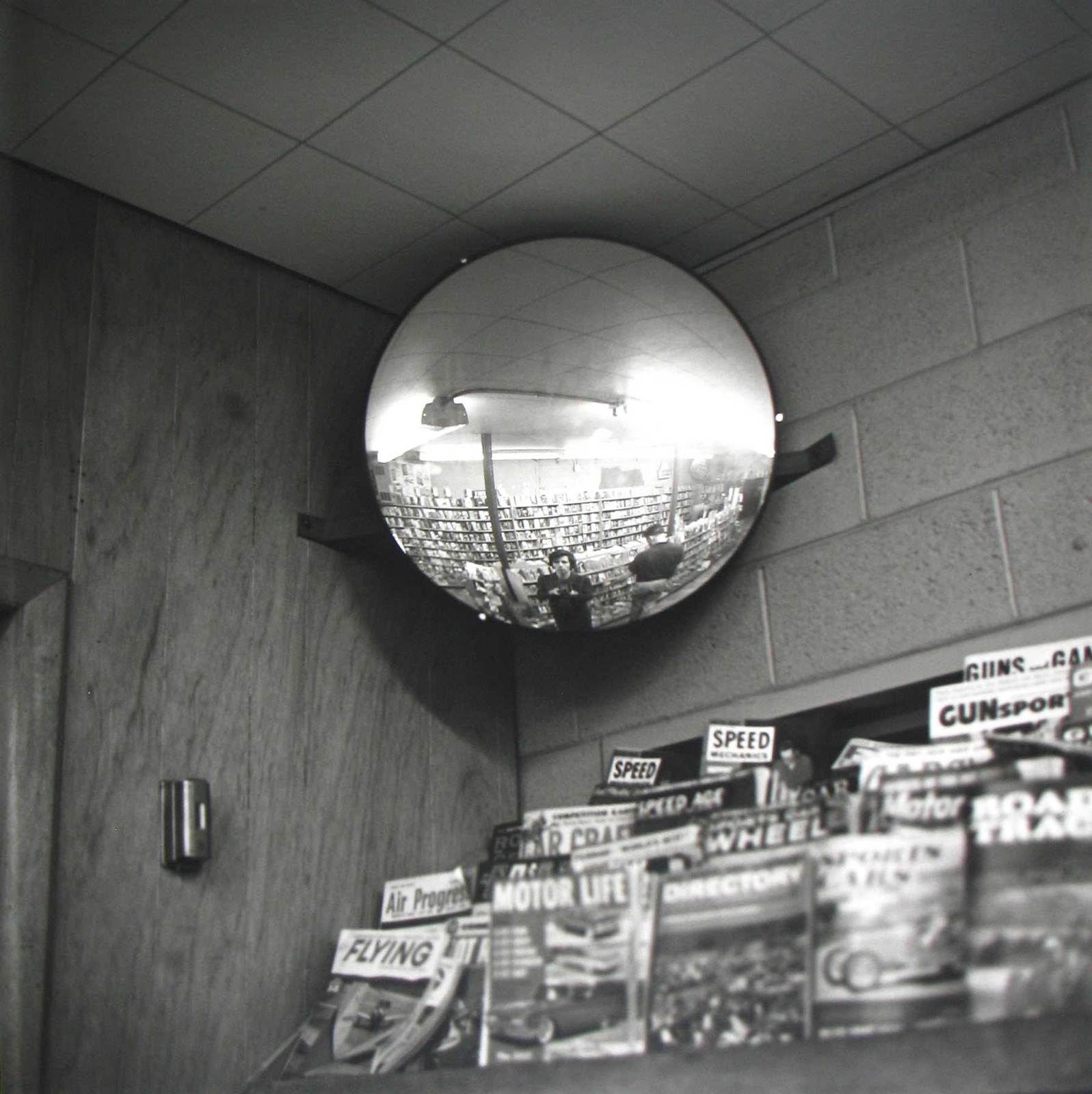 a mirror hanging from the ceiling of a store