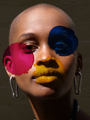 a woman with her face painted with different colors