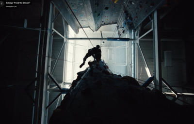 a man climbing up the side of a climbing wall