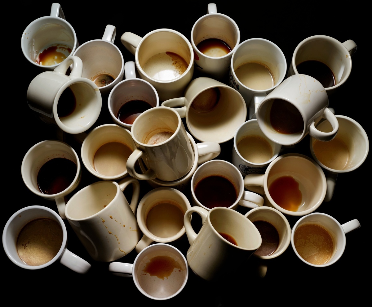 a pile of coffee cups sitting on top of a table