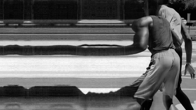 a black and white photo of a man walking down the street