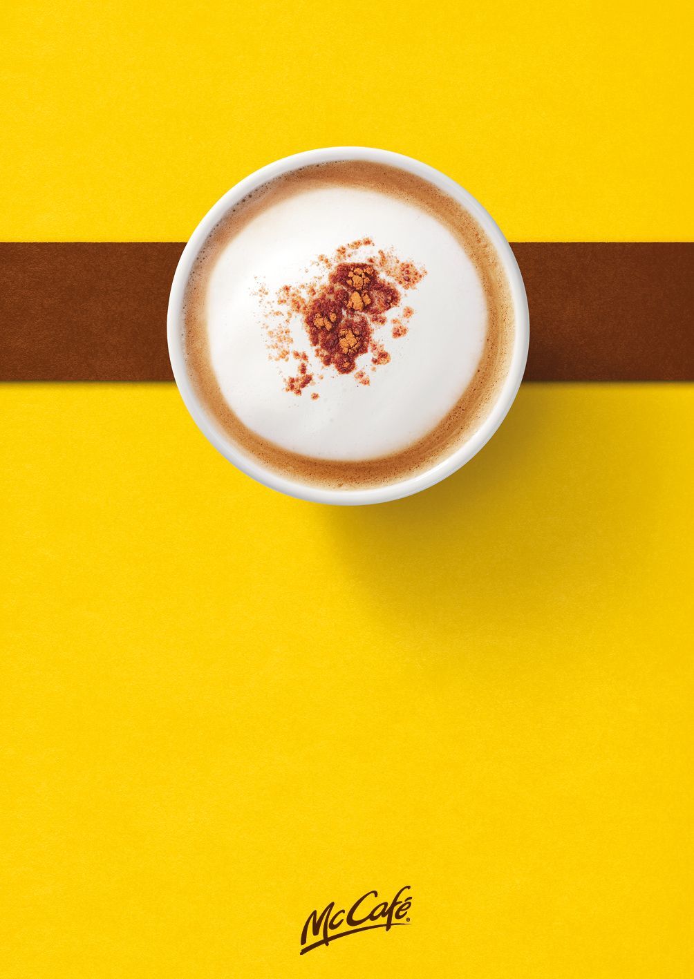 a cup of cappuccino on a yellow table