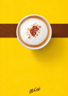 a cup of cappuccino on a yellow table