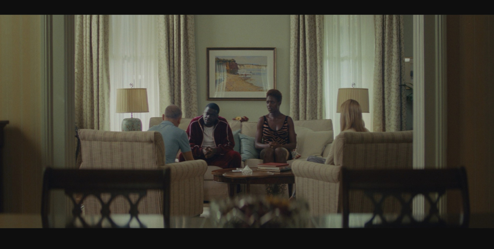 a group of people sitting around a living room