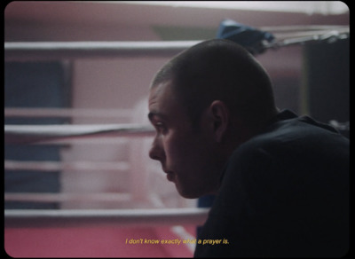 a man in a boxing ring looking at something