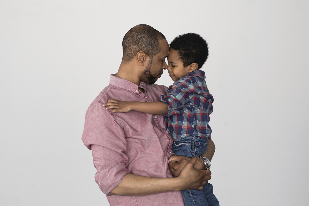 a man holding a small child in his arms