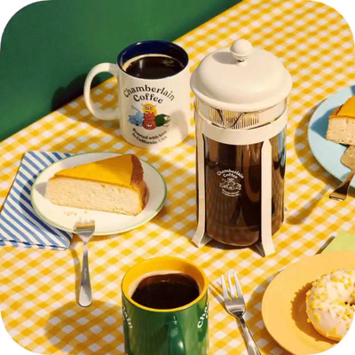 a table topped with a slice of cake next to a cup of coffee