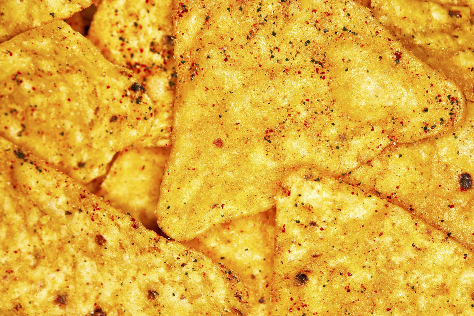 a pile of tortilla chips sitting on top of a table