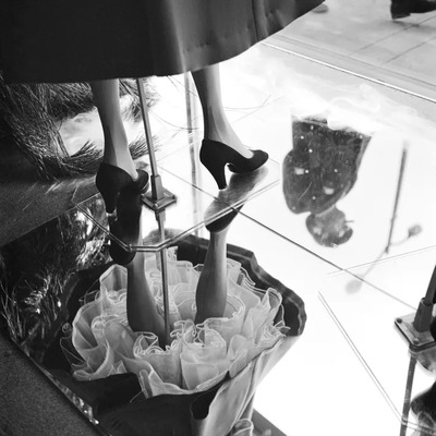 a woman's legs in high heels on a glass table