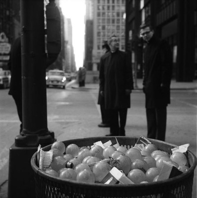 a basket full of apples sitting on the side of a street