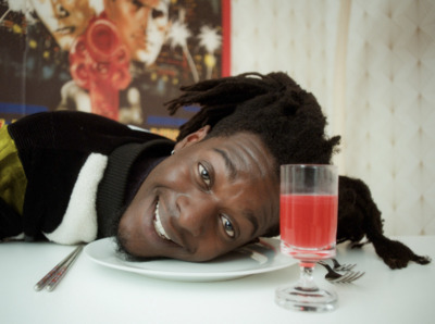 a woman laying on a table with a plate of food and a glass of wine