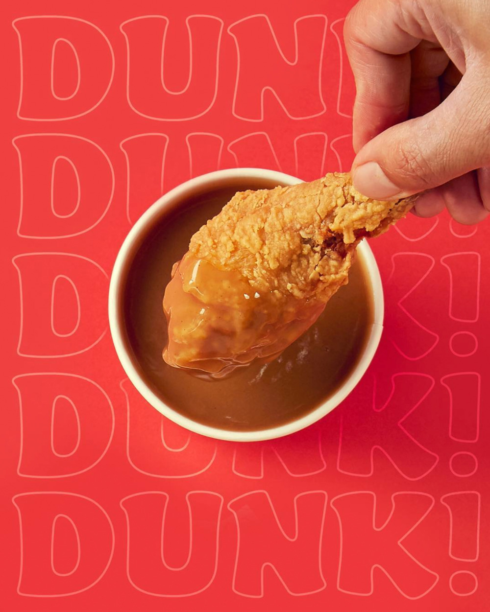 a person dipping something into a bowl of dipping sauce