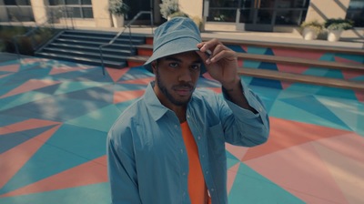 a man in a blue shirt and orange tie