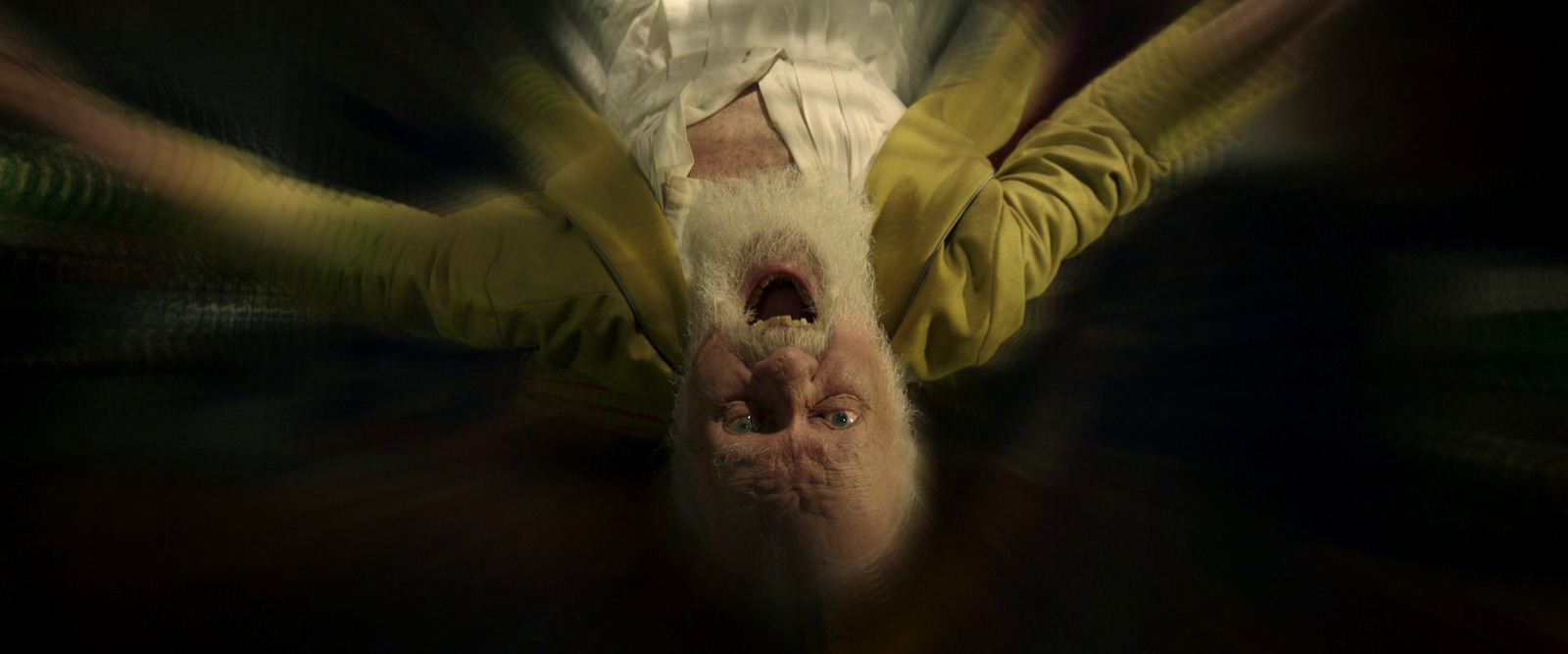 a person in a yellow shirt is upside down