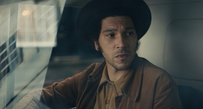 a man wearing a hat sitting in a car