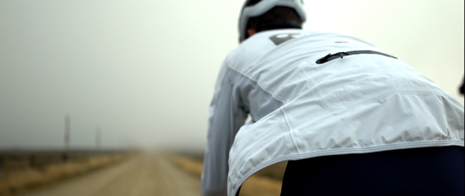 a man riding a bike down a dirt road