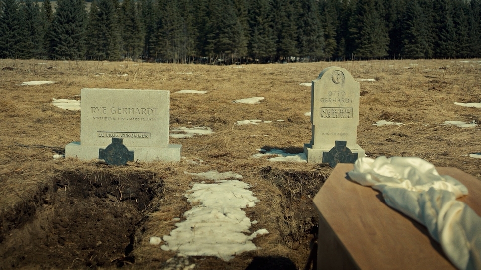 a couple of headstones sitting on top of a field