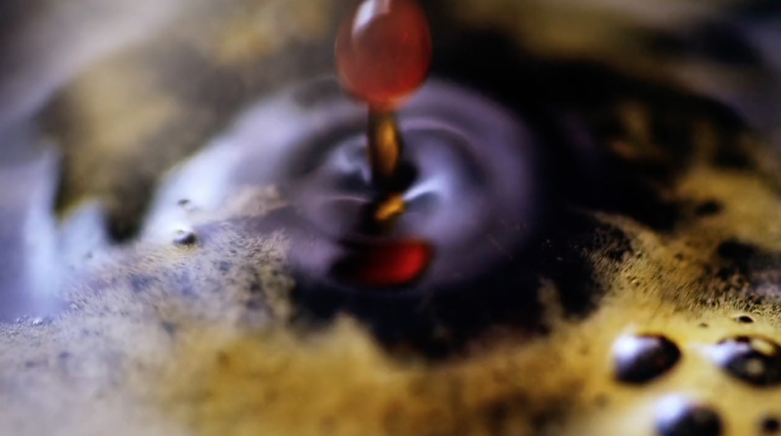 a drop of liquid is being poured into a puddle