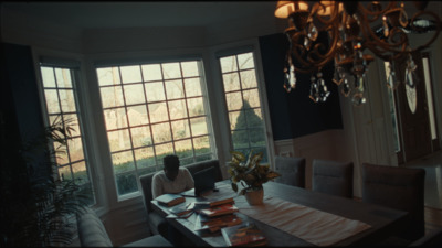 a woman sitting at a table in front of a window