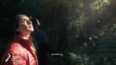 a woman in a red jacket looking up into the sky