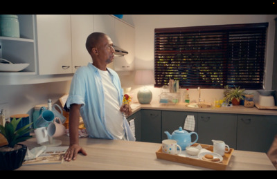 a man standing in a kitchen next to a counter