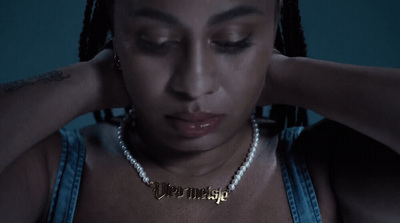 a woman wearing a necklace with a name on it