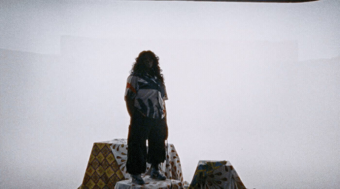 a man standing on top of a snow covered hill