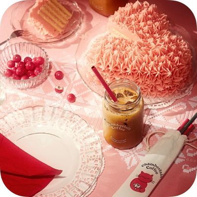 a table topped with cakes and drinks on top of a table