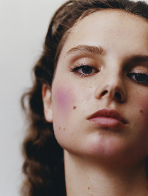 a close up of a woman's face with makeup on