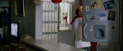 a man standing in front of a refrigerator in a kitchen