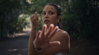 a woman holding her hand up in the air