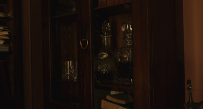 a wooden cabinet with glass doors in a room