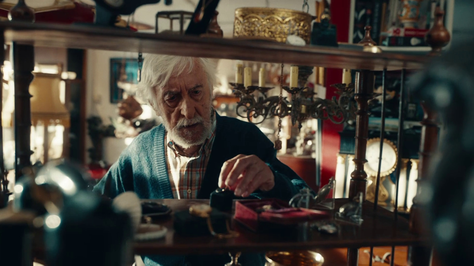 an old man sitting at a table in a room