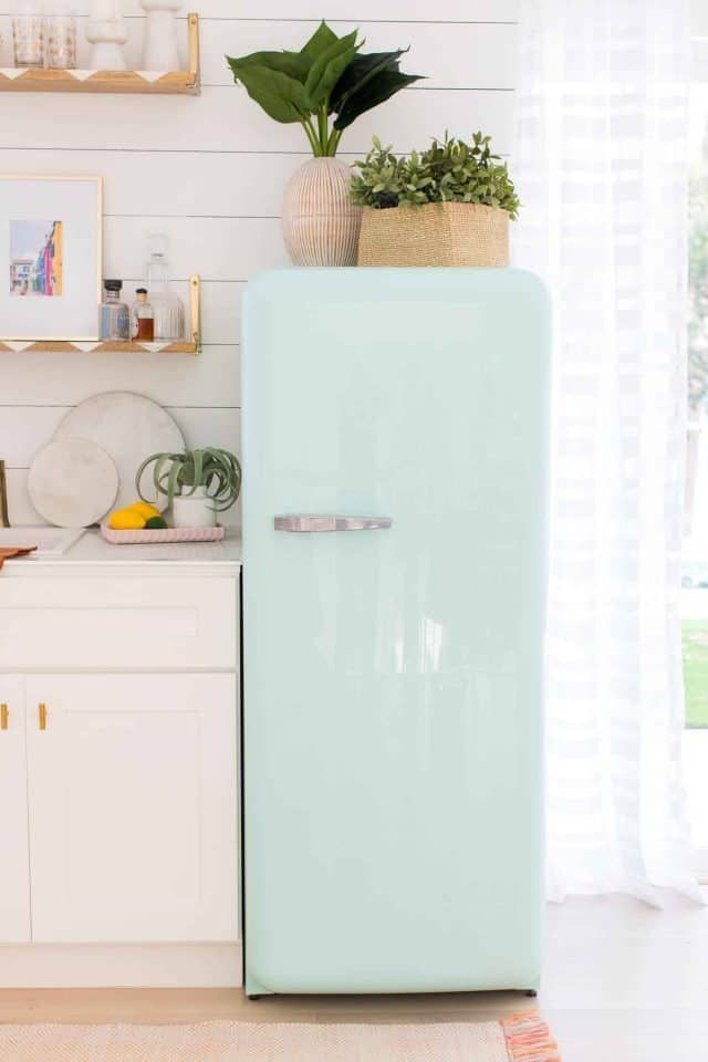 a mint green refrigerator in a white kitchen