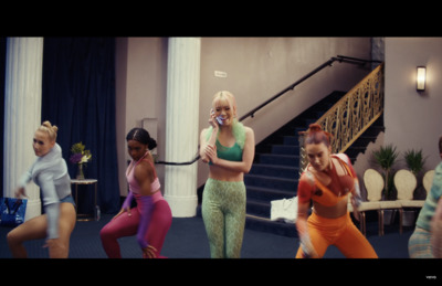 a group of young women dancing around each other