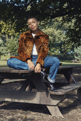 a woman sitting on a bench in a park