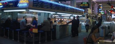 a group of people standing around a restaurant