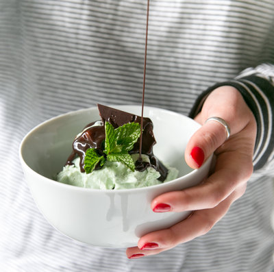 a woman is holding a bowl of ice cream