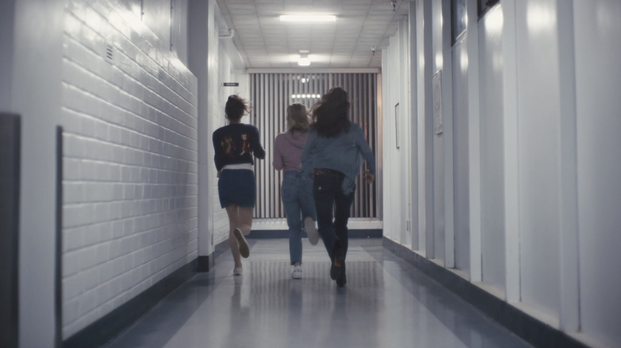 a group of people walking down a hallway