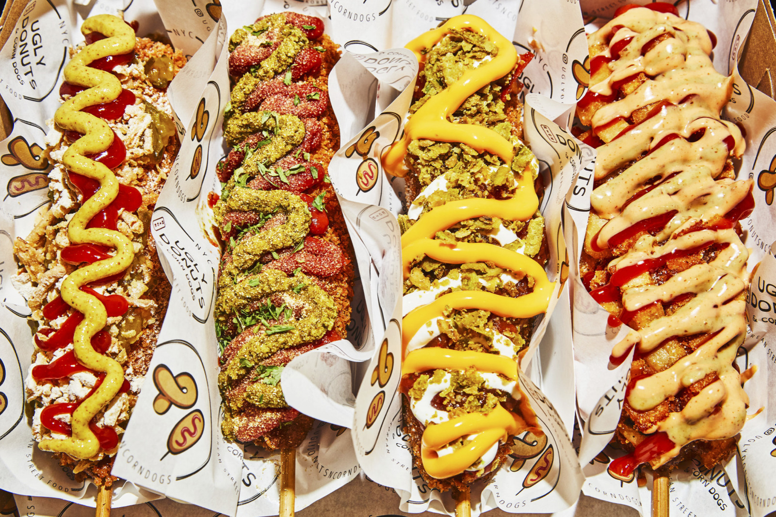 a box filled with different types of hot dogs